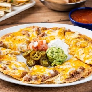 Grande Bean & Cheese Nachos: Tostada chips topped with refried beans and melted mixed cheese. Served with guacamole, sour cream, pico de gallo and pickled jalapeños.